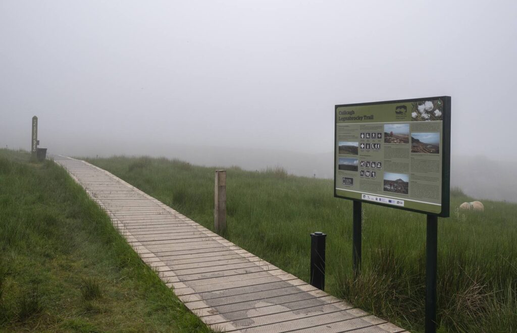 Wooden boardwalk of the Cuilcagh Legnabrocky Trail disappearing into fog
