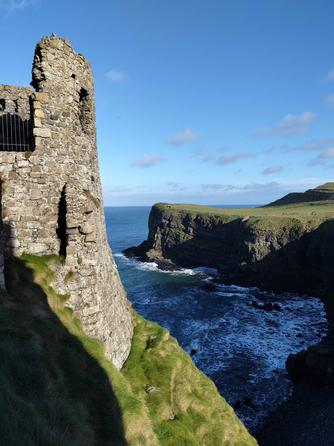 Dunluce Castle ruins overlooking a bay on the Antrim coast