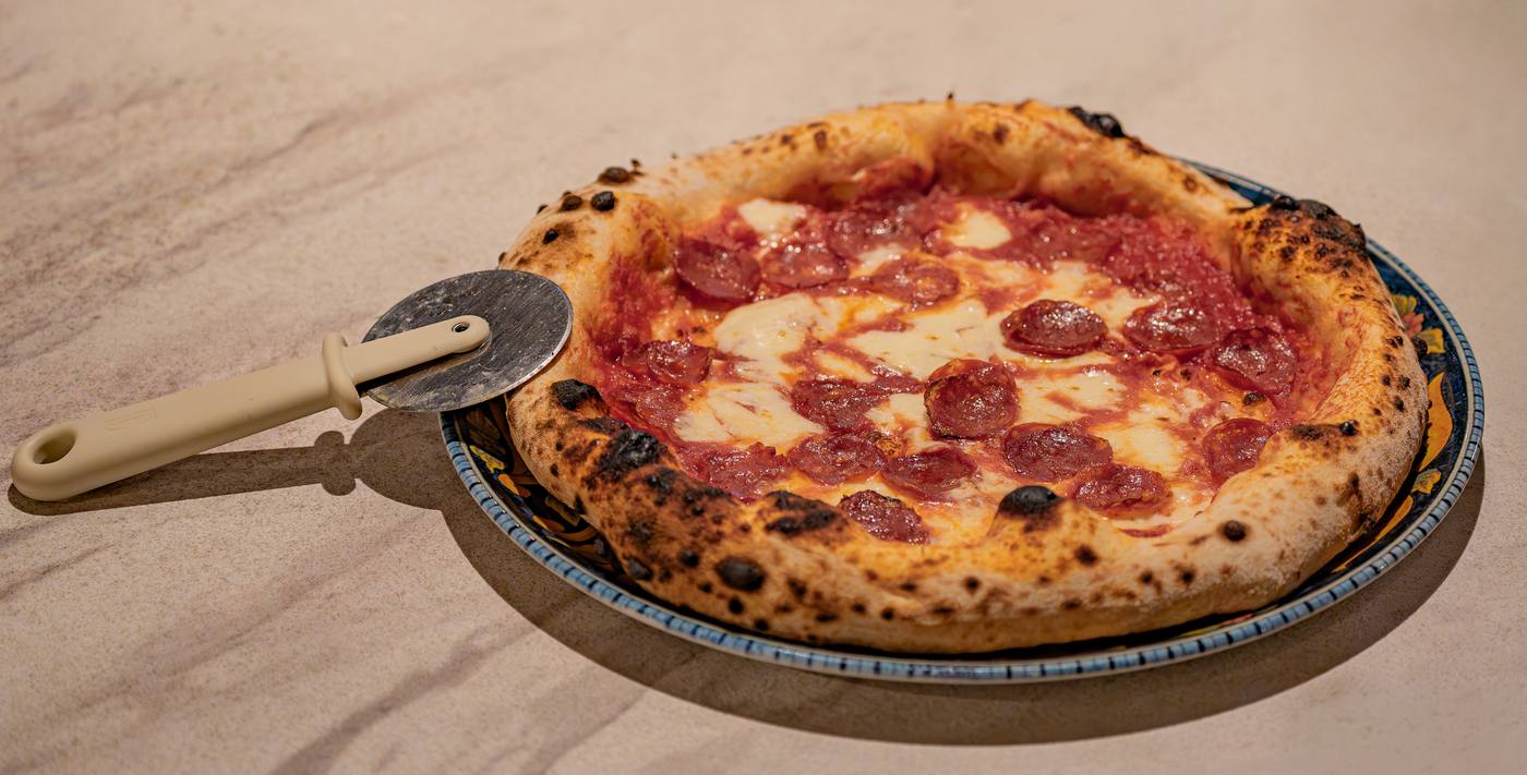 A Neapolitan pizza with a charred, puffy crust