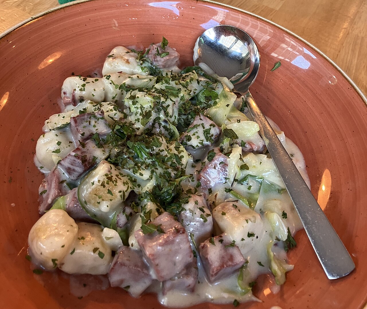Boxty dumplings served with bacon and cabbage in a creamy sauce