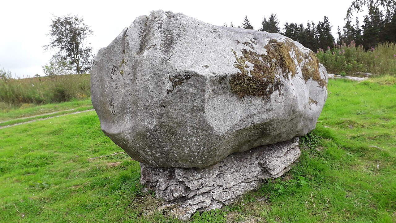 A glacial erratic boulder resting on limestone bedrock at Cavan Burren Park