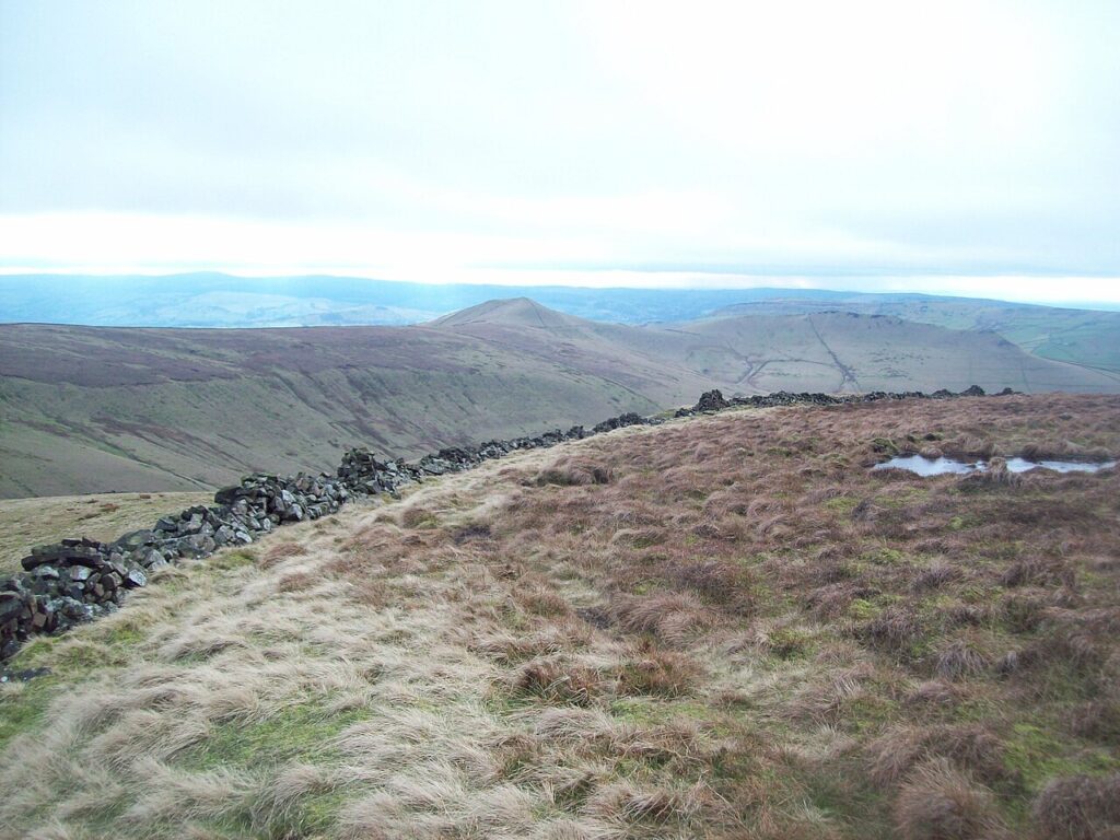A dry stone wall running across open moorland, the kind of boundary that divides Irish townlands