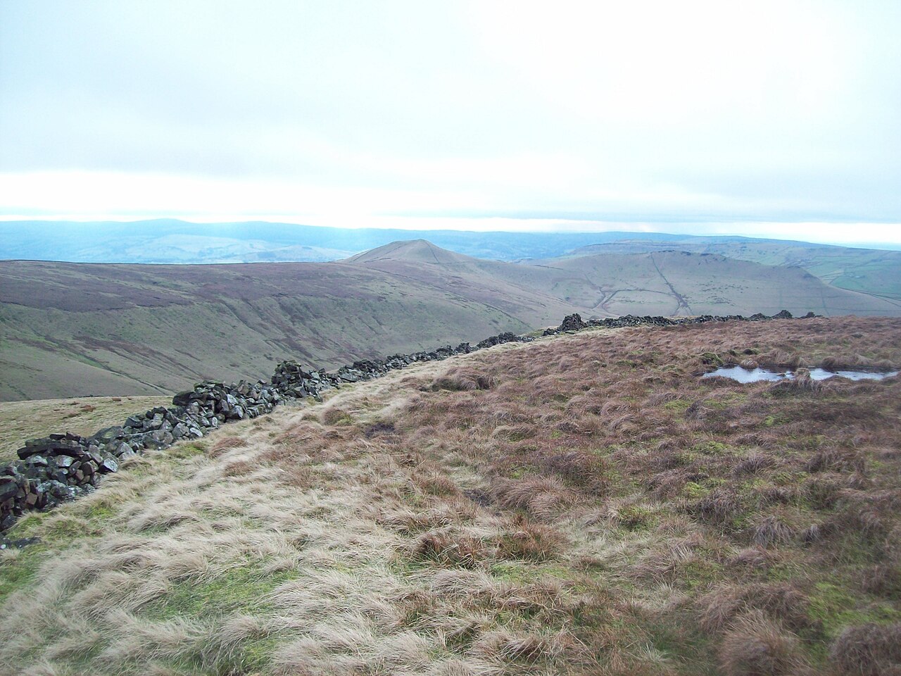 A dry stone wall running across open moorland, the kind of boundary that divides Irish townlands