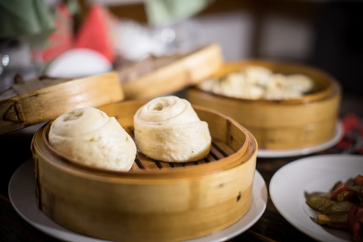 Close-up of steamed buns in bamboo steamers, showcasing the unique flavors of Asian cuisine.